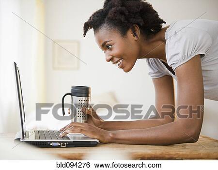 Black woman using laptop View Large Photo Image Stock Photograph - Black woman using laptop. Fotosearch