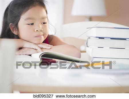 Bored Korean girl doing homework View Large Photo Image Stock Photo - Bored Korean girl doing homework. Fotosearch