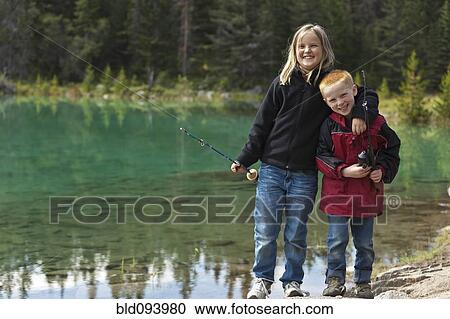 Stock Image - Brother and sister fishing in the Valley of the Five Lakes. Fotosearch