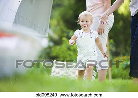 Stock Photo - Caucasian baby running in grass. Fotosearch