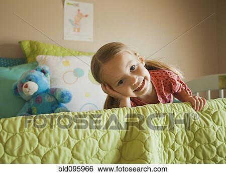 Caucasian girl laying on bed View Large Photo Image Stock Photograph - Caucasian girl laying on bed. Fotosearch