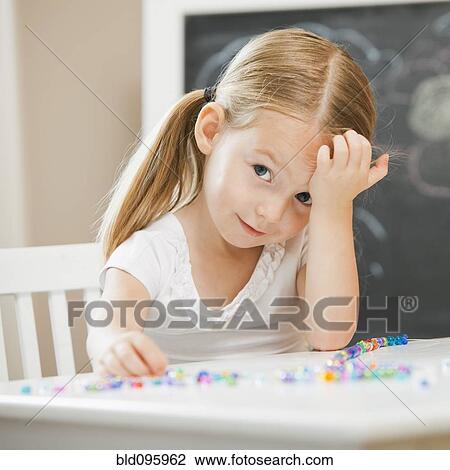 Caucasian girl stringing beads View Large Photo Image Stock Image - Caucasian girl stringing beads. Fotosearch
