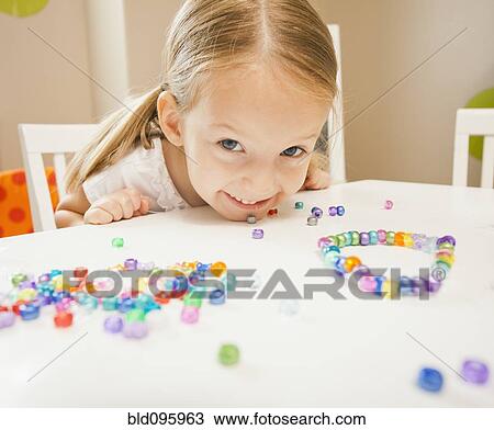 Caucasian girl stringing beads View Large Photo Image Stock Image - Caucasian girl stringing beads. Fotosearch