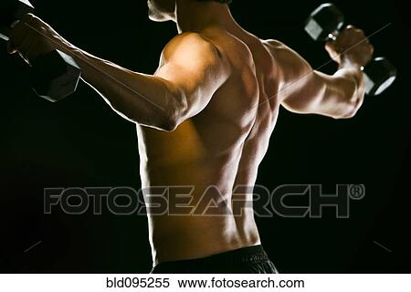 Caucasian man exercising with dumbbells View Large Photo Image Stock Photography - Caucasian man exercising with dumbbells. Fotosearch