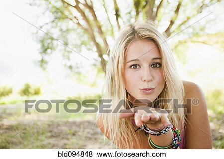 Caucasian woman blowing a kiss View Large Photo Image Stock Photo - Caucasian woman blowing a kiss. Fotosearch
