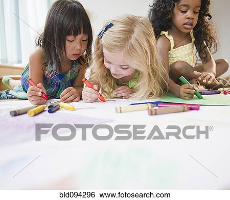 Stock Photograph - Children laying on floor coloring together. Fotosearch