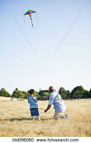 Chinese grandfather and grandson flying kite View Large Photo Image Stock Image - Chinese grandfather and grandson flying kite. Fotosearch