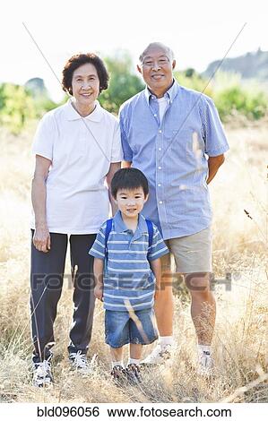 Chinese grandparents standing in field with grandson View Large Photo Image Stock Photograph - Chinese grandparents standing in field with grandson. Fotosearch