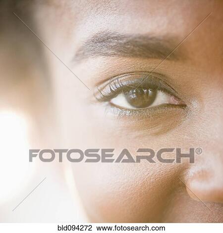 Stock Image - Close up of Black woman's eye. Fotosearch