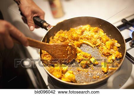 Stock Image - Close up of person making pad thai. Fotosearch