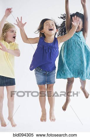 Excited girls jumping together View Large Photo Image Stock Photography - Excited girls jumping together. Fotosearch