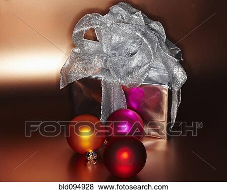 Stock Photo - Festive Christmas gift with colored ornaments. Fotosearch