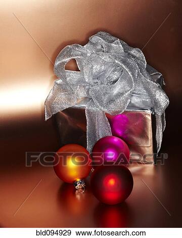 Stock Photo - Festive Christmas gift with colored ornaments. Fotosearch