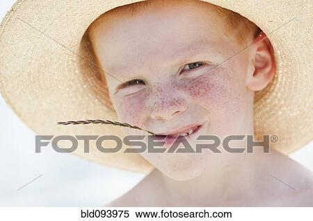 Freckled boy in hat chewing on straw View Large Photo Image Stock Photography - Freckled boy in hat chewing on straw. Fotosearch
