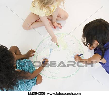 Girls sitting on floor drawing globe together View Large Photo Image Stock Photograph - Girls sitting on floor drawing globe together. Fotosearch