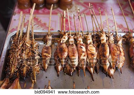 Stock Image - Grilled fish and squid in market. Fotosearch
