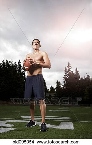 Hispanic athlete holding football View Large Photo Image Picture - Hispanic athlete holding football. Fotosearch
