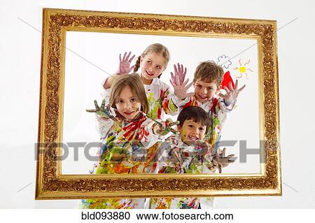 Stock Image - Hispanic children covered in paint inside frame. Fotosearch