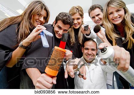 Stock Photograph - Hispanic clients and stylists in beauty salon. Fotosearch