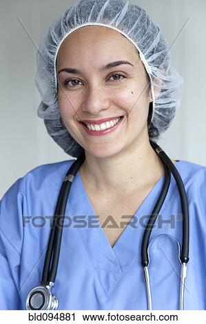 Stock Image - Hispanic doctor in scrubs and surgical cap. Fotosearch