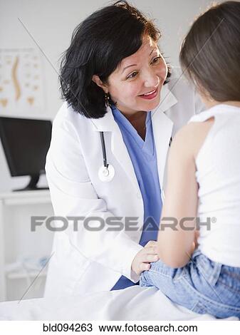 Stock Image - Hispanic doctor talking to patient. Fotosearch