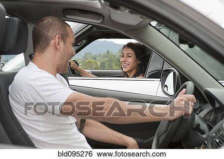 Stock Photograph - Hispanic drivers stopping to talk. Fotosearch