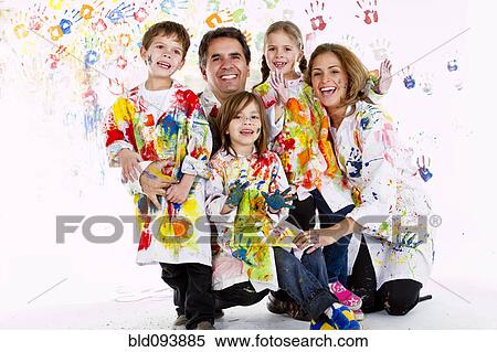 Stock Photography - Hispanic family covered in paint. Fotosearch