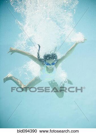 Hispanic girl jumping into swimming pool View Large Photo Image Stock Image - Hispanic girl jumping into swimming pool. Fotosearch