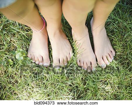 Hispanic Girls Feet Standing In Grass Stock Image Bld Fotosearch