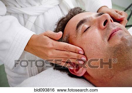 Stock Photograph - Hispanic man having face massage. Fotosearch