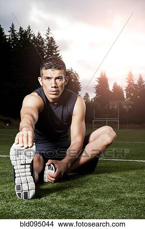 Hispanic man stretching before exercise View Large Photo Image Picture - Hispanic man stretching before exercise. Fotosearch