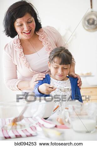 Hispanic mother and daughter baking together View Large Photo Image Stock Image - Hispanic mother and daughter baking together. Fotosearch