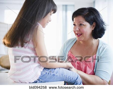 Hispanic mother comforting daughter View Large Photo Image Stock Photo - Hispanic mother comforting daughter. Fotosearch