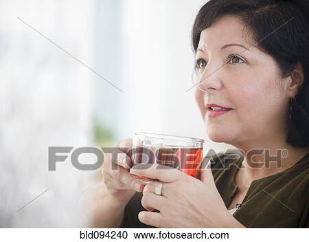 Hispanic woman drinking tea View Large Photo Image Stock Image - Hispanic woman drinking tea. Fotosearch