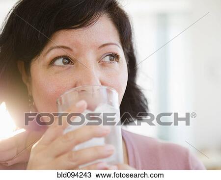 Stock Image - Hispanic woman drinking water. Fotosearch