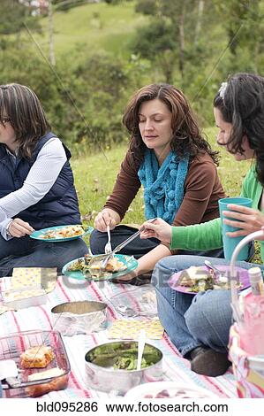 Hispanic woman enjoying picnic View Large Photo Image Stock Photograph - Hispanic woman enjoying picnic. Fotosearch
