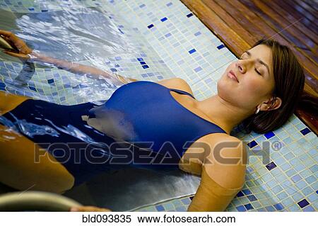 Hispanic woman enjoying swimming pool View Large Photo Image Stock Photography - Hispanic woman enjoying swimming pool. Fotosearch