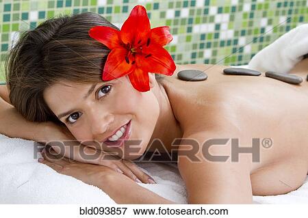Hispanic woman having hot stone therapy View Large Photo Image Stock Photo - Hispanic woman having hot stone therapy. Fotosearch