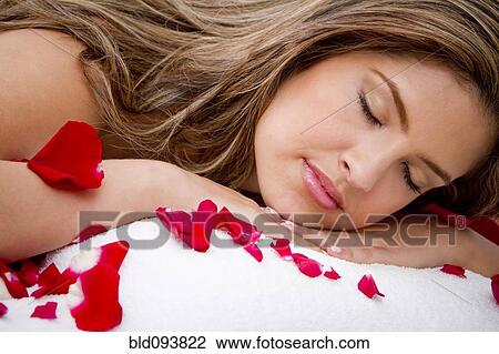 Hispanic woman laying on massage table covered in rose petals View Large Photo Image Stock Image - Hispanic woman laying on massage table covered in rose petals. Fotosearch