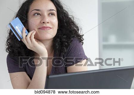 Hispanic woman shopping online with credit card View Large Photo Image Stock Photo - Hispanic woman shopping online with credit card. Fotosearch