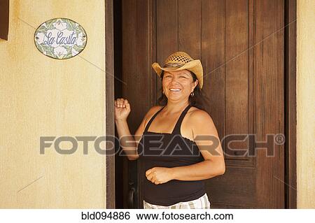 Hispanic woman standing in doorway View Large Photo Image Stock Photograph - Hispanic woman standing in doorway. Fotosearch