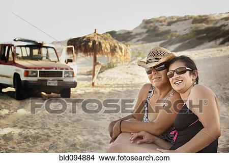 Picture - Hispanic women enjoying the beach. Fotosearch