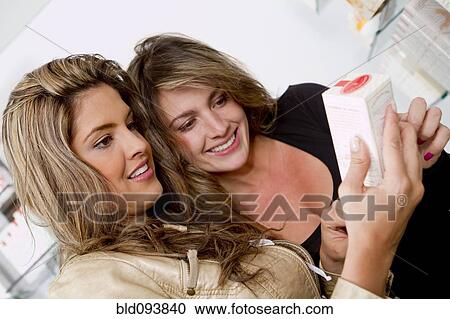 Stock Image - Hispanic women looking at food package. Fotosearch