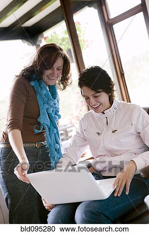 Hispanic women using laptop together View Large Photo Image Stock Image - Hispanic women using laptop together. Fotosearch