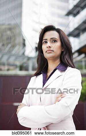 Indian businesswoman standing outdoors with arms crossed View Large Photo Image Stock Image - Indian businesswoman standing outdoors with arms crossed. Fotosearch