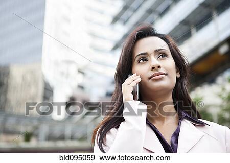 Indian businesswoman talking on cell phone View Large Photo Image Stock Photo - Indian businesswoman talking on cell phone. Fotosearch