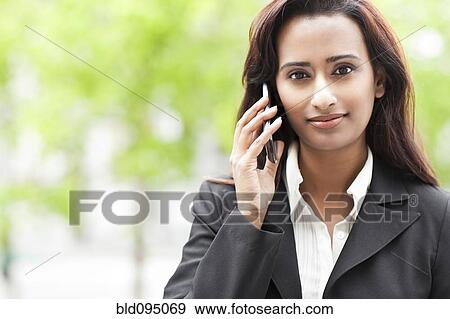 Stock Photo - Indian businesswoman talking on cell phone. Fotosearch