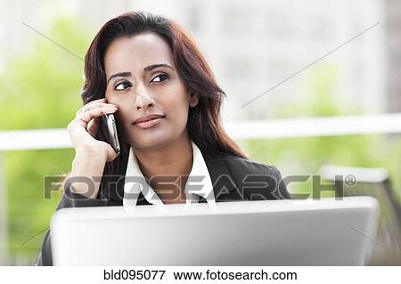 Stock Photo - Indian businesswoman talking on cell phone. Fotosearch