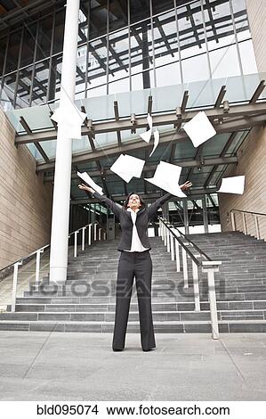 Indian businesswoman throwing papers into the air View Large Photo Image Picture - Indian businesswoman throwing papers into the air. Fotosearch