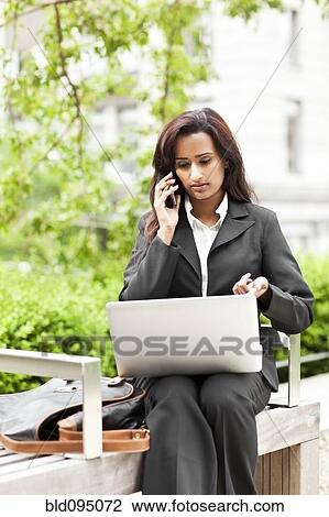 Indian businesswoman using laptop outdoors View Large Photo Image Stock Image - Indian businesswoman using laptop outdoors. Fotosearch
